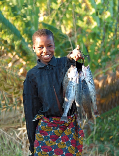 A girl hold an abundance of fish