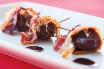 Dates stuffed with goat cheese wrapped in beef bacon.